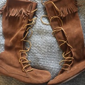 Minnetonka lace up knee high boots.